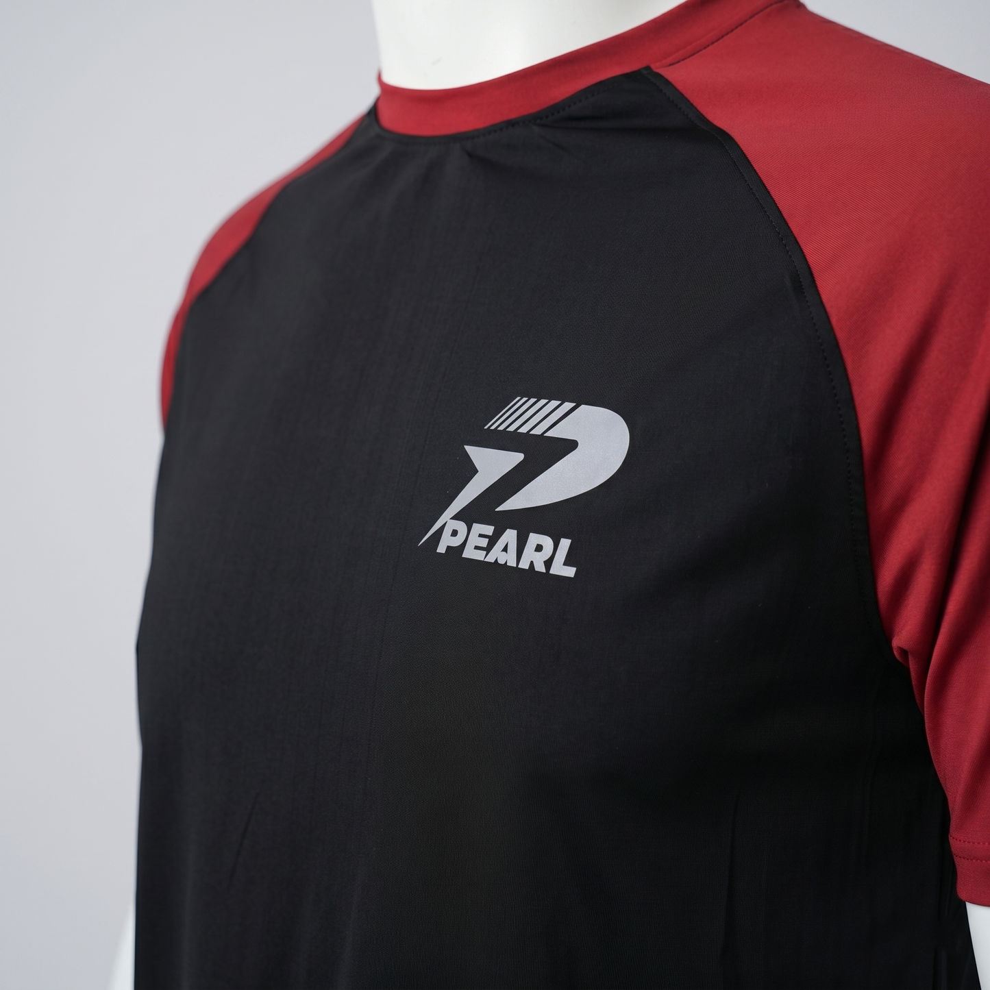 Close-up of high-quality black breathable athletic fabric with red stitching