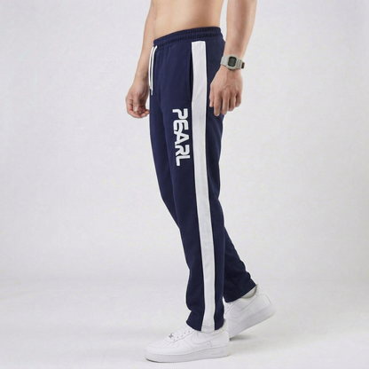 Navy blue athletic pants with white Pearl branding - Side view