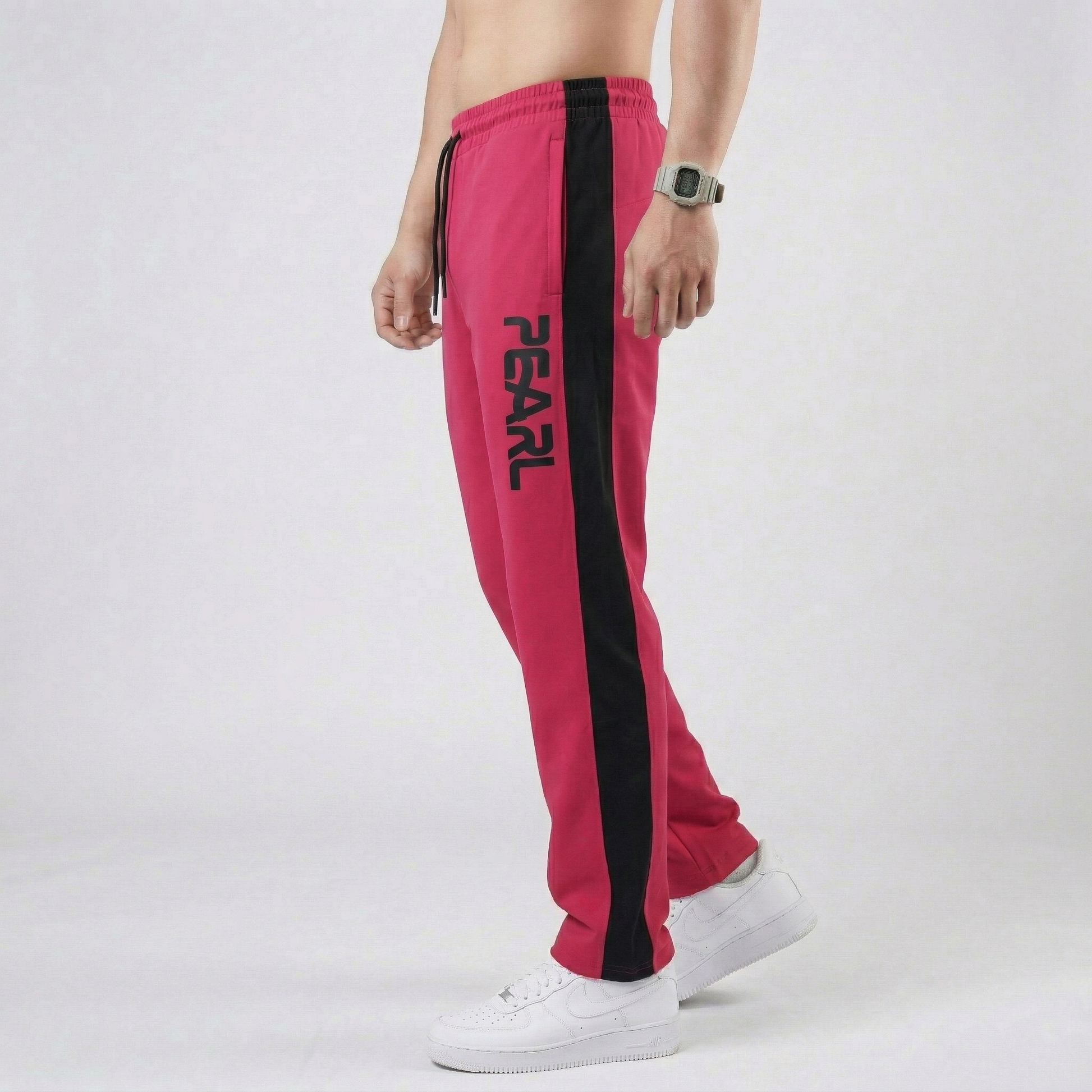 Close-up of white Pearl branding on cherry red athletic joggers